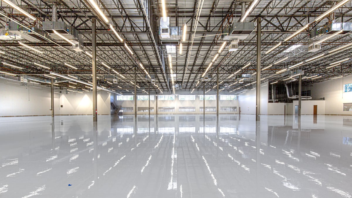 Polished concrete floor in a large commercial warehouse space